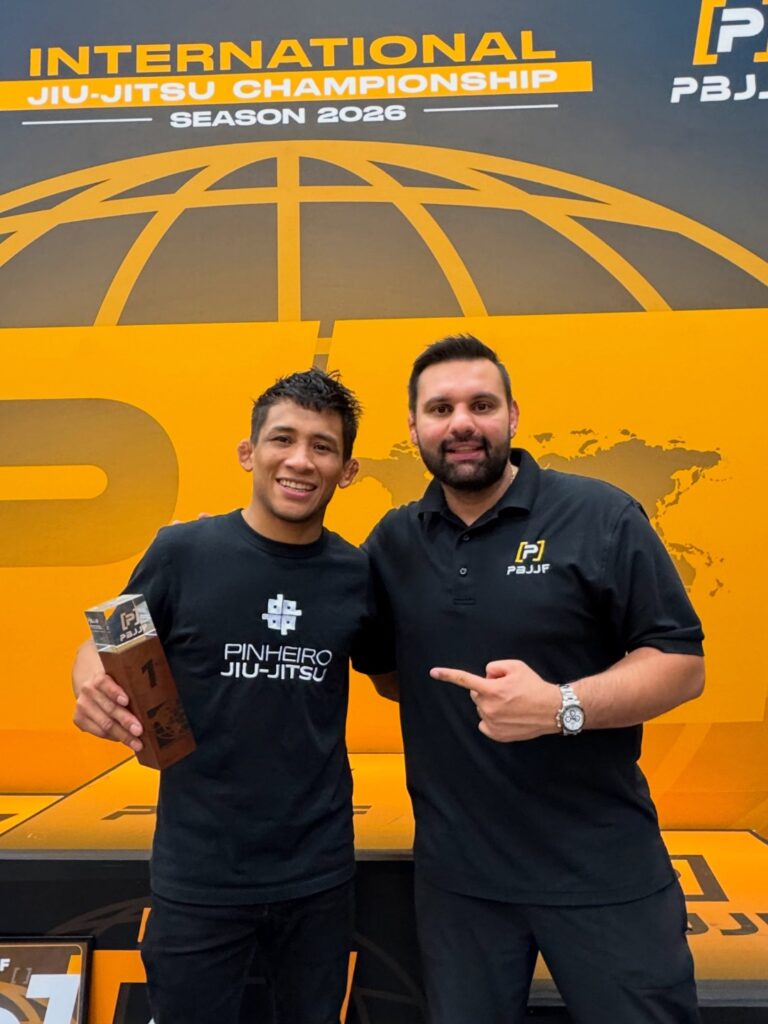 Lucas Pinheiro: “Jiu-jitsu is not made only of athletes” 1 Lucas Pinheiro holds the first-place trophy next to a PBJJF representative at the Orlando Open